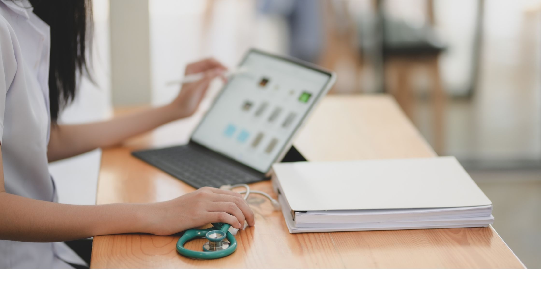 Nurse practitioner using EHR telehealth platform to schedule virtual patient care with a laptop