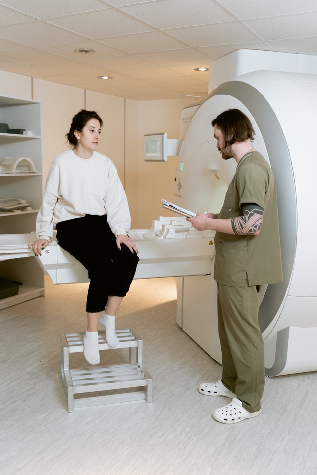 young woman preparing for breast mri scan to detect cellular cancer in hospital