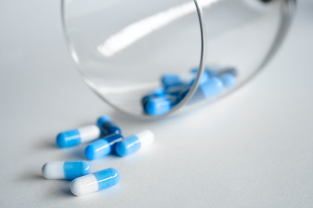blue white pills medications left out of the prescription bottle