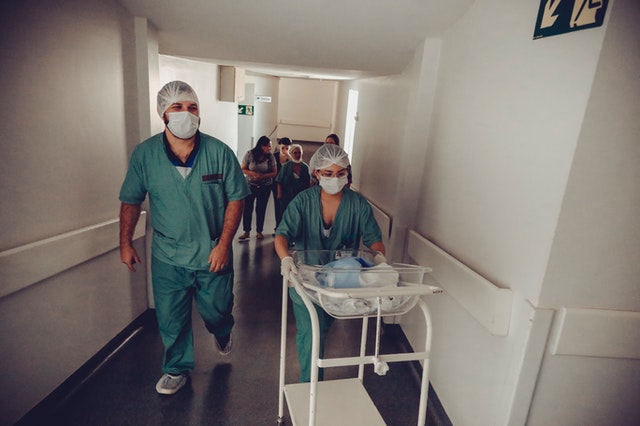 Pediatric nicu team taking preemie baby to mothers hospital ward