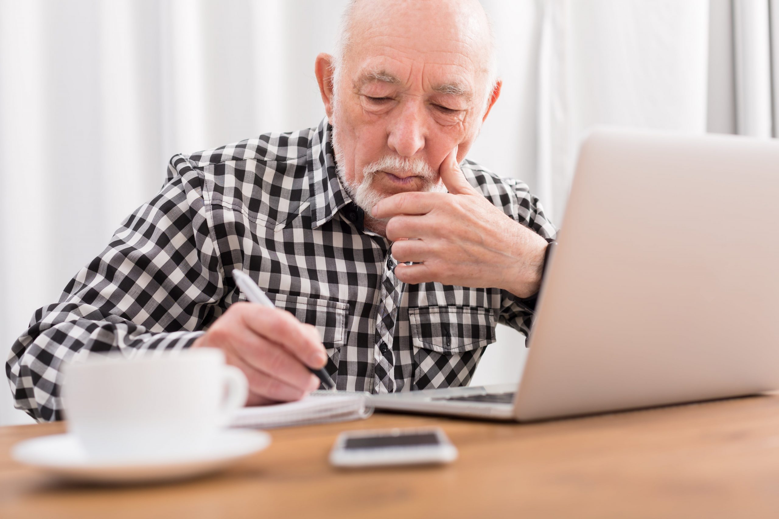 elderly senior ciitizen reviewing health documents for his chronic health condition
