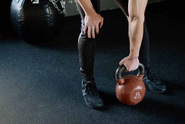 strength training by picking up gym kettle balls