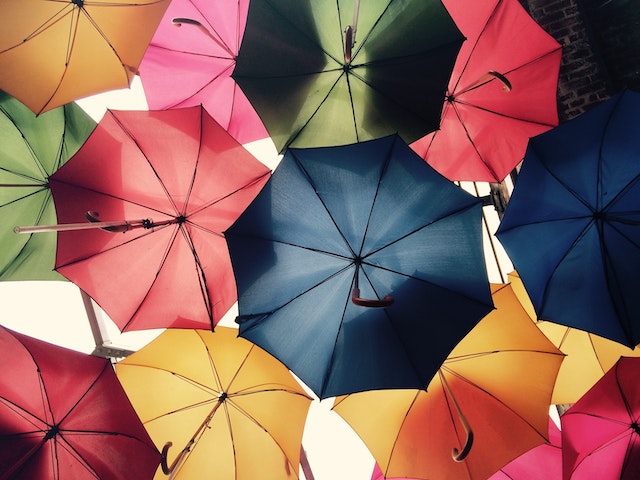 colorful umbrellas suspendd over a tourist area